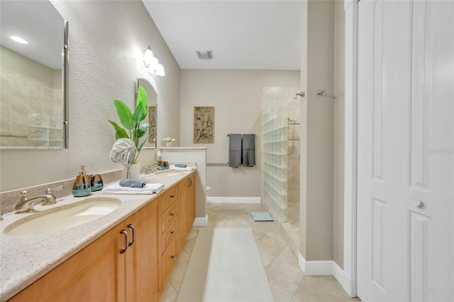 full bath with a sink, walk in shower, and tile patterned floors