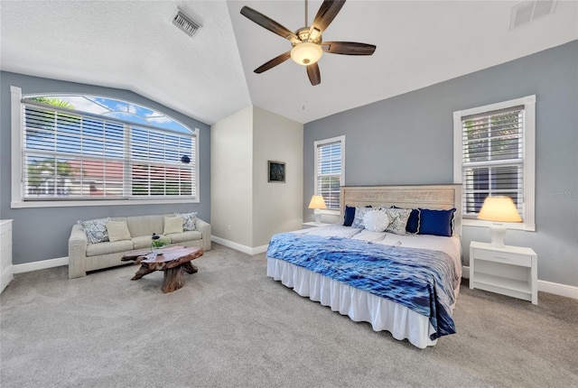 carpeted bedroom featuring a ceiling fan, visible vents, baseboards, and lofted ceiling