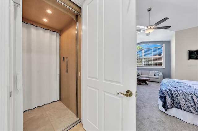 bedroom with light colored carpet, ceiling fan, elevator, and recessed lighting