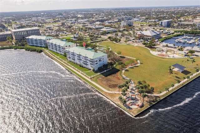drone / aerial view featuring a city view and a water view