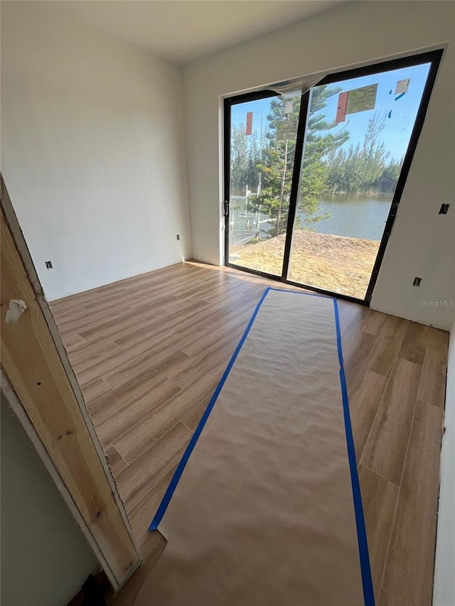 10522 Riverside Rd, Port Charlotte, FL 33981 - empty room with wood finished floors and a water view