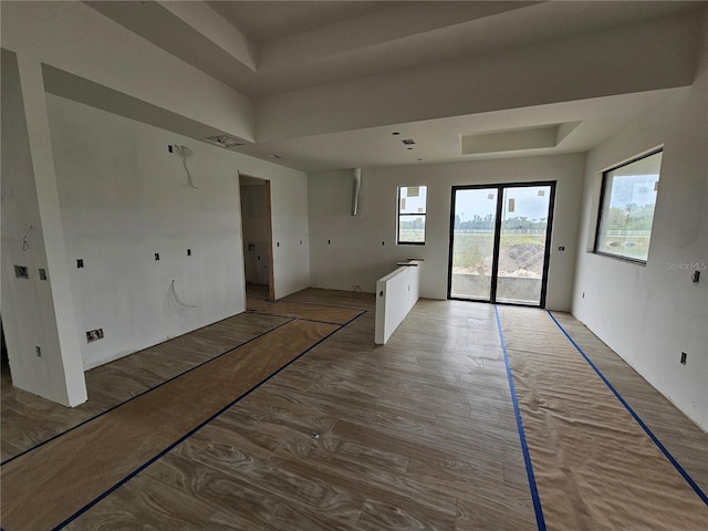 10522 Riverside Rd, Port Charlotte, FL 33981 - empty room with a raised ceiling and light wood finished floors