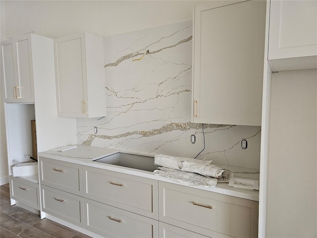 10522 Riverside Rd, Port Charlotte, FL 33981 - kitchen with light countertops, white cabinetry, and dark wood-type flooring