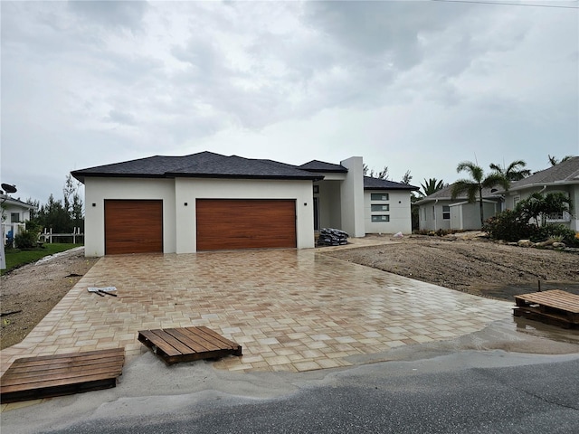 10522 Riverside Rd, Port Charlotte, FL 33981 - view of front of house featuring stucco siding, an attached garage, and decorative driveway