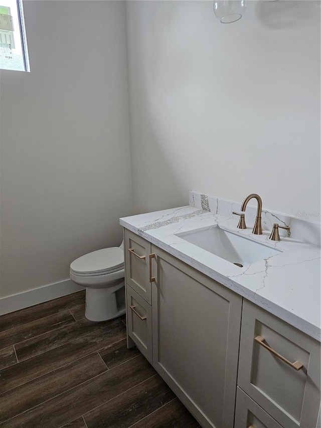10522 Riverside Rd, Port Charlotte, FL 33981 - bathroom with vanity, toilet, wood finished floors, and baseboards