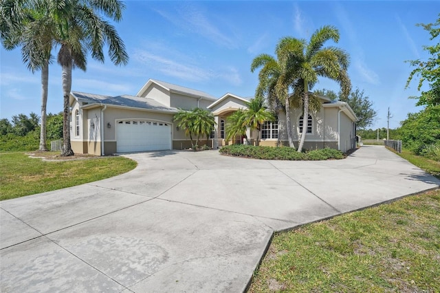 1811 Irving Ave, Lehigh Acres, FL 33972 - ranch-style house with stucco siding, a garage, driveway, and a front lawn