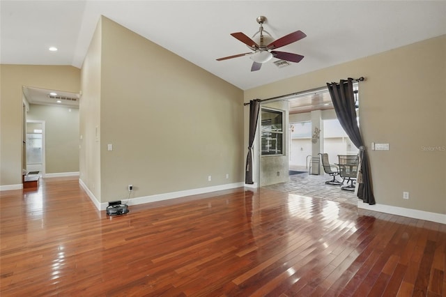 1811 Irving Ave, Lehigh Acres, FL 33972 - spare room with vaulted ceiling, hardwood / wood-style floors, a ceiling fan, and baseboards