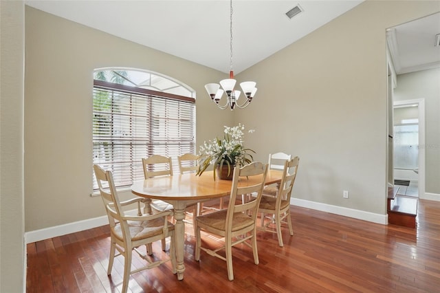 1811 Irving Ave, Lehigh Acres, FL 33972 - dining area featuring hardwood / wood-style floors, a chandelier, baseboards, and lofted ceiling