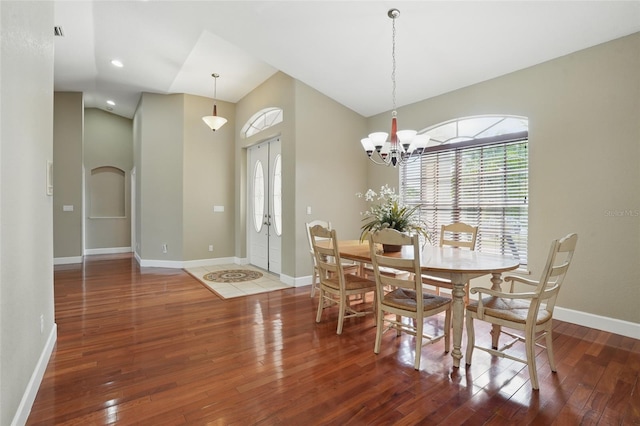 1811 Irving Ave, Lehigh Acres, FL 33972 - dining room with baseboards, hardwood / wood-style floors, vaulted ceiling, a chandelier, and recessed lighting