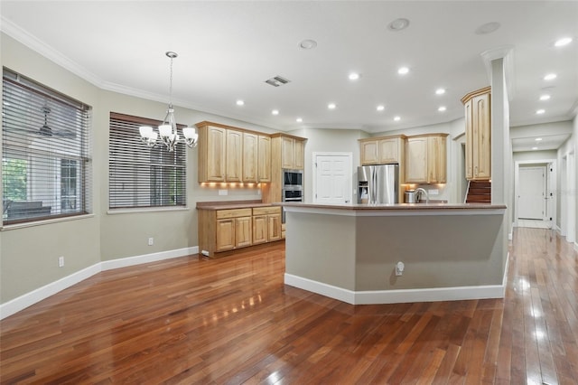 1811 Irving Ave, Lehigh Acres, FL 33972 - kitchen with stainless steel appliances, a chandelier, light brown cabinetry, a peninsula, and light wood-type flooring