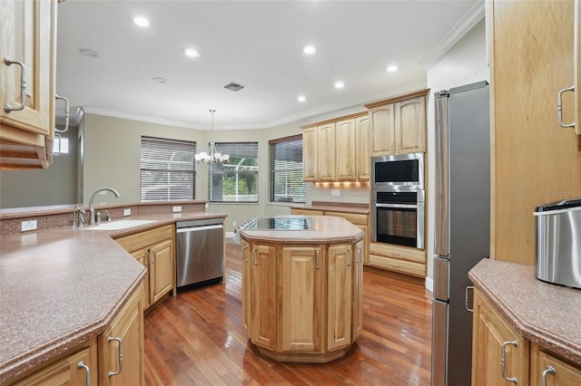1811 Irving Ave, Lehigh Acres, FL 33972 - kitchen featuring stainless steel appliances, a sink, crown molding, hardwood / wood-style floors, and a chandelier