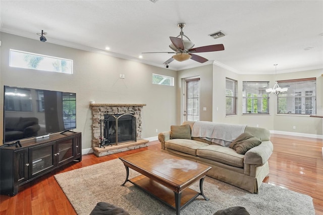 1811 Irving Ave, Lehigh Acres, FL 33972 - living room featuring a chandelier, wood finished floors, a fireplace, crown molding, and ceiling fan