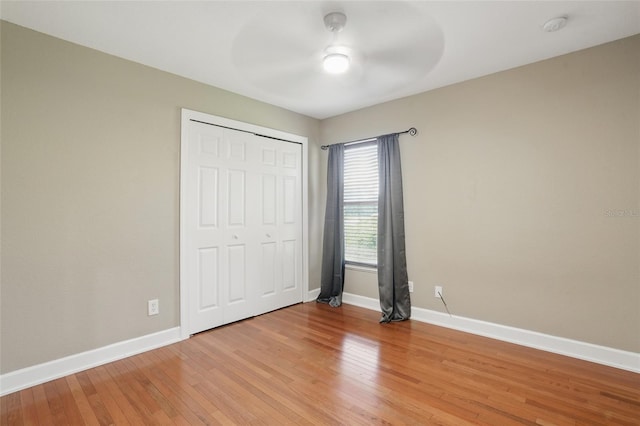 1811 Irving Ave, Lehigh Acres, FL 33972 - unfurnished bedroom with light wood-type flooring, baseboards, a closet, and a ceiling fan