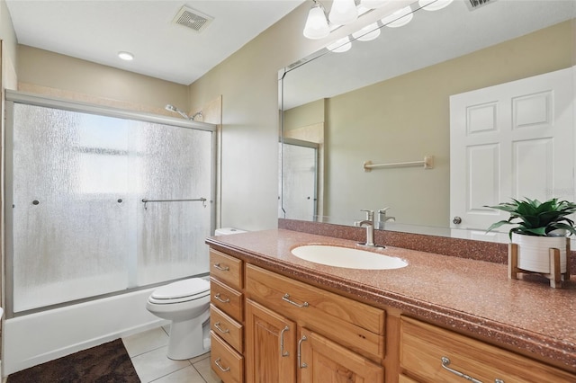 1811 Irving Ave, Lehigh Acres, FL 33972 - full bath featuring tile patterned flooring, vanity, toilet, and shower / bath combination with glass door