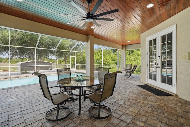 1811 Irving Ave, Lehigh Acres, FL 33972 - view of patio / terrace featuring french doors, an outdoor pool, glass enclosure, ceiling fan, and outdoor dining area
