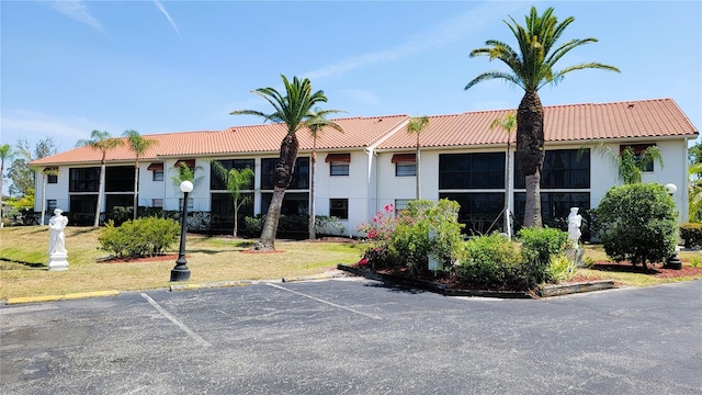 view of property with uncovered parking