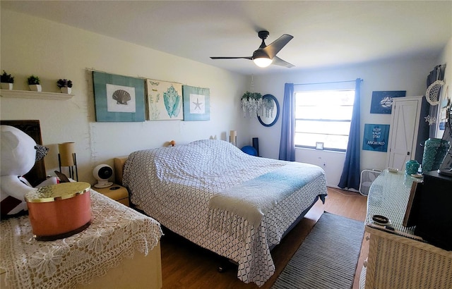 bedroom with a ceiling fan and wood finished floors