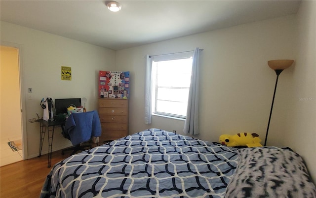bedroom with wood finished floors