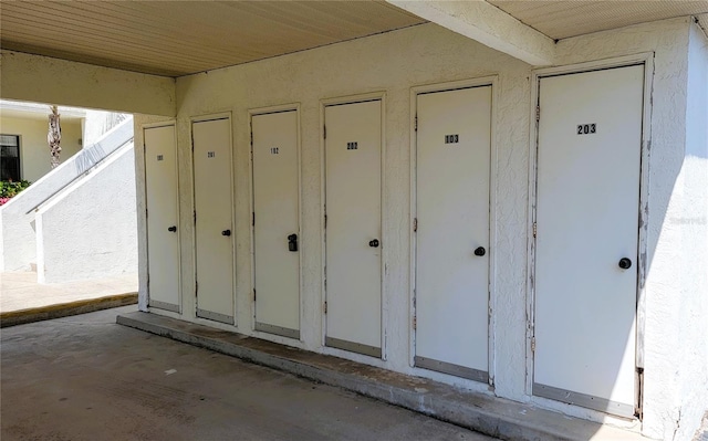 exterior details with stucco siding and mail area