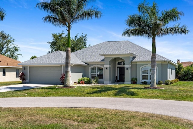 27147 Guapore Dr, Punta Gorda, FL 33983 - ranch-style home featuring a garage, concrete driveway, a front lawn, and stucco siding