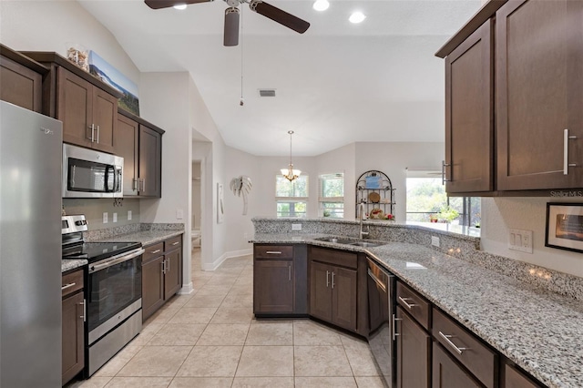 27147 Guapore Dr, Punta Gorda, FL 33983 - kitchen with lofted ceiling, dark brown cabinetry, stainless steel appliances, and ceiling fan with notable chandelier
