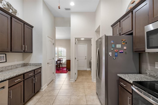 27147 Guapore Dr, Punta Gorda, FL 33983 - kitchen featuring dark brown cabinetry, appliances with stainless steel finishes, and visible vents