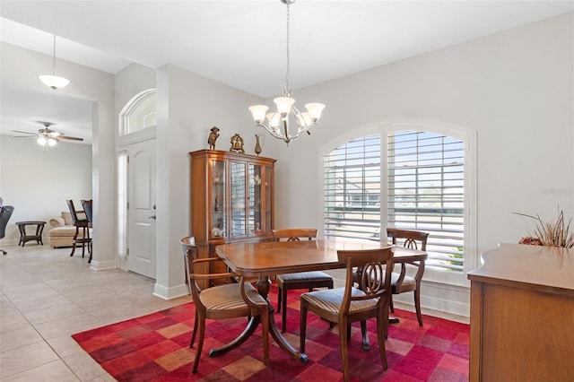 27147 Guapore Dr, Punta Gorda, FL 33983 - dining space with baseboards, light tile patterned floors, and ceiling fan with notable chandelier