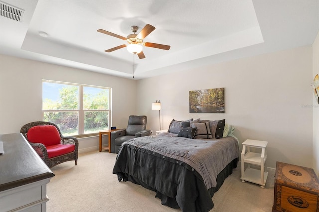 27147 Guapore Dr, Punta Gorda, FL 33983 - bedroom with ceiling fan, a tray ceiling, light colored carpet, baseboards, and visible vents