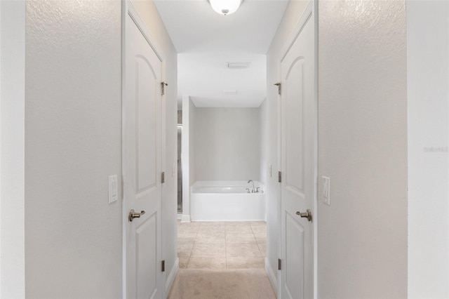 27147 Guapore Dr, Punta Gorda, FL 33983 - hallway featuring visible vents, baseboards, and light tile patterned floors