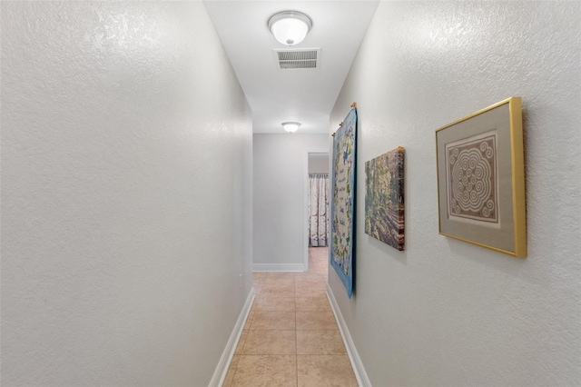 27147 Guapore Dr, Punta Gorda, FL 33983 - corridor featuring baseboards, visible vents, a textured wall, and light tile patterned floors