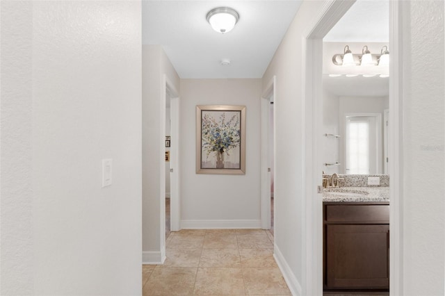 27147 Guapore Dr, Punta Gorda, FL 33983 - hall with baseboards, a sink, and light tile patterned floors