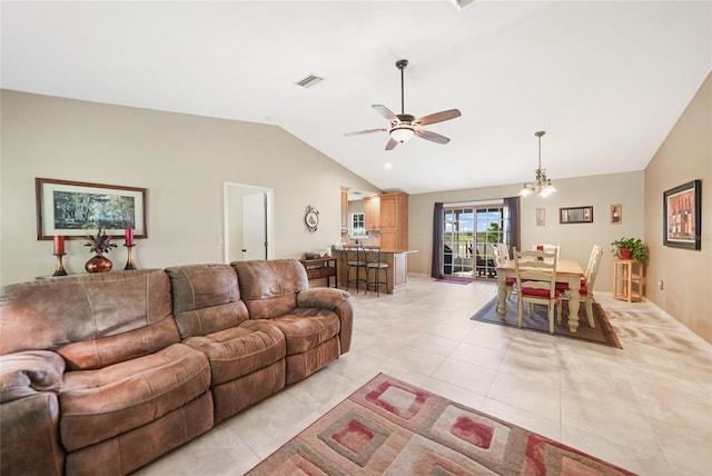 living area with lofted ceiling, visible vents, light tile patterned floors, and ceiling fan with notable chandelier