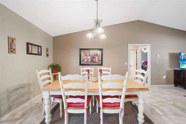dining room featuring a chandelier, lofted ceiling, and baseboards