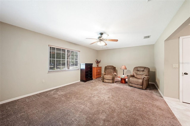 sitting room featuring light carpet, baseboards, visible vents, and ceiling fan