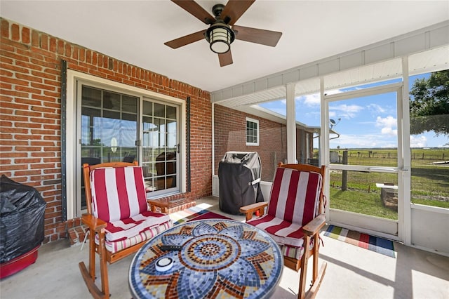 sunroom / solarium featuring ceiling fan