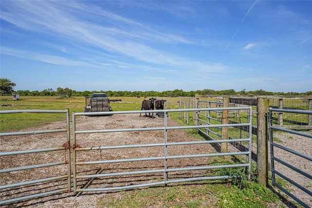 view of yard with a rural view and an exterior structure