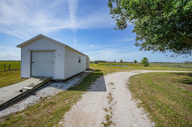 view of shed with a rural view