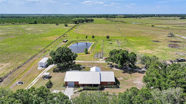 birds eye view of property with a water view and a rural view