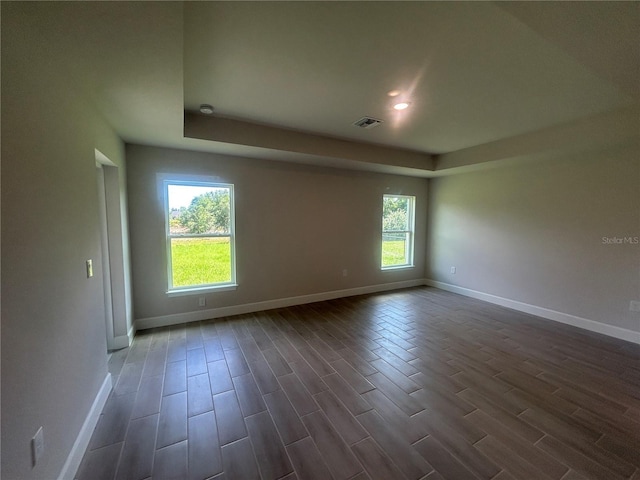 23245 Jules Ave, Port Charlotte, FL 33980 - spare room featuring wood finish floors, a tray ceiling, and recessed lighting