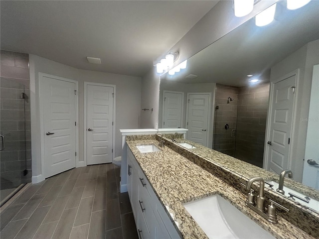 23245 Jules Ave, Port Charlotte, FL 33980 - bathroom featuring a shower stall, double vanity, a closet, and wood finish floors
