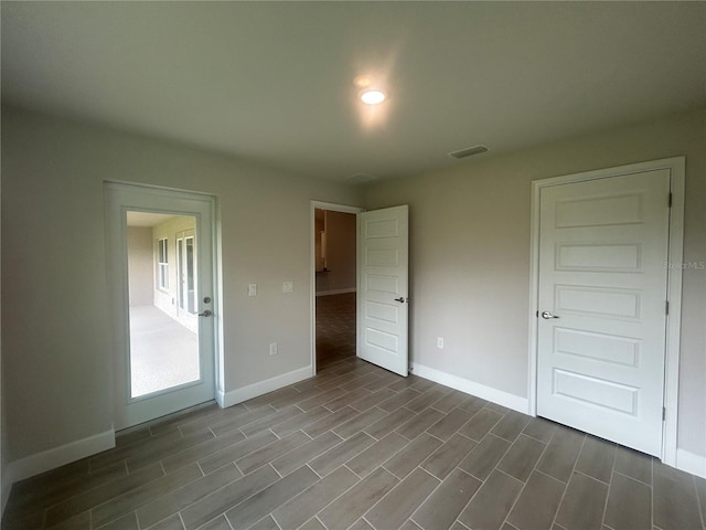 23245 Jules Ave, Port Charlotte, FL 33980 - unfurnished bedroom with wood finish floors and baseboards