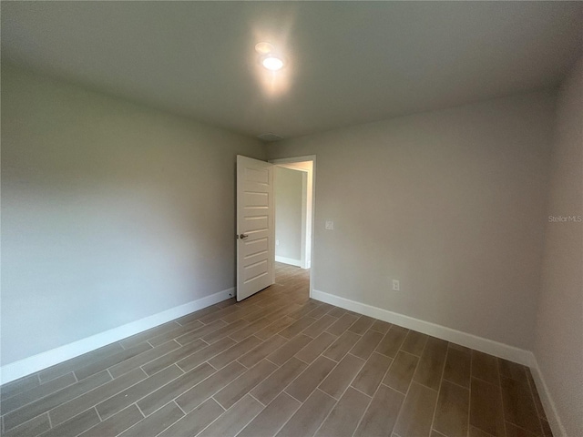 23245 Jules Ave, Port Charlotte, FL 33980 - unfurnished room with baseboards and wood finished floors