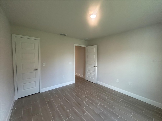 23245 Jules Ave, Port Charlotte, FL 33980 - empty room featuring baseboards and dark wood-style flooring