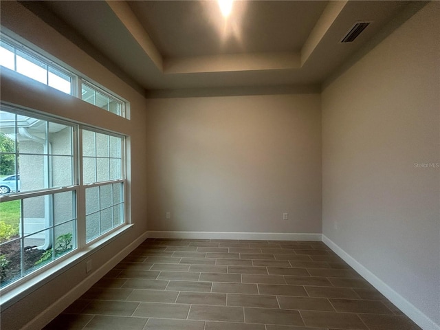 23245 Jules Ave, Port Charlotte, FL 33980 - spare room with a tray ceiling and baseboards