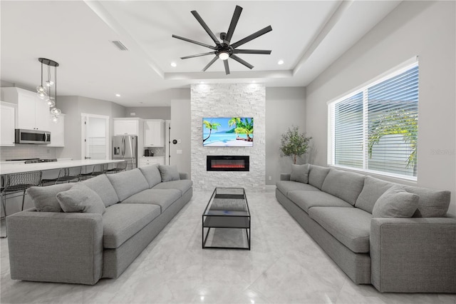 2186 Florala St, North Port, FL 34287 - living room with visible vents, recessed lighting, a ceiling fan, a fireplace, and a raised ceiling