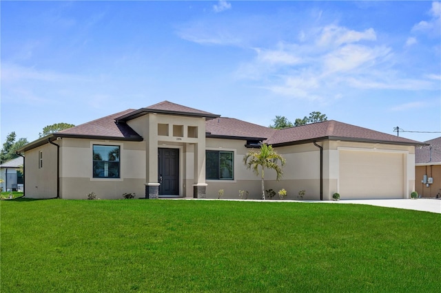 2186 Florala St, North Port, FL 34287 - prairie-style house with a front lawn, a garage, stucco siding, and concrete driveway