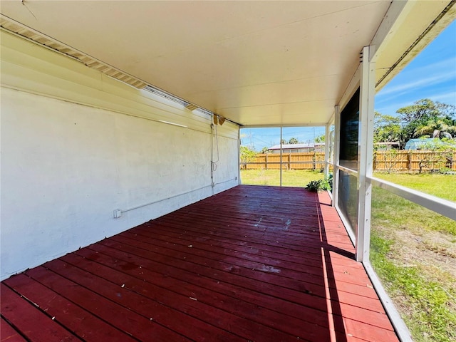wooden deck featuring a lawn and fence