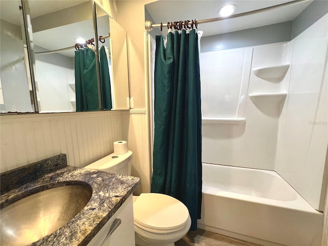 bathroom featuring shower / tub combo, toilet, and vanity