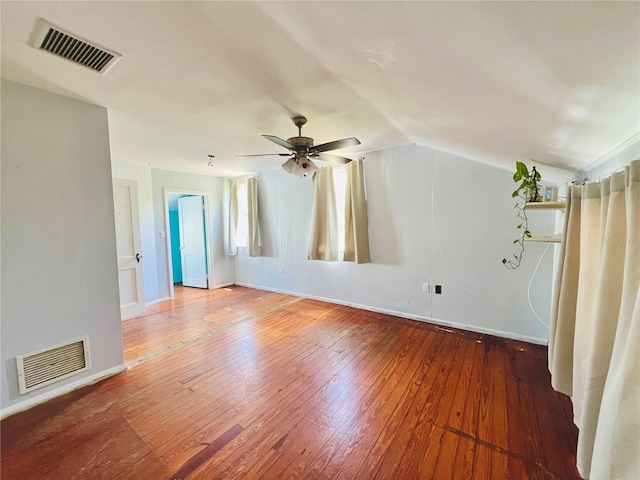 additional living space with lofted ceiling, baseboards, hardwood / wood-style flooring, and visible vents