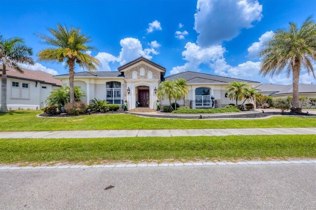 3866 Turtle Dove Blvd, Punta Gorda, FL 33950 - view of front of house with stucco siding, a front yard, and stone siding